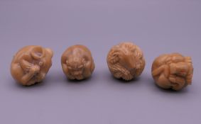 Four nut formed netsuke. Each approximately 3 cm high.