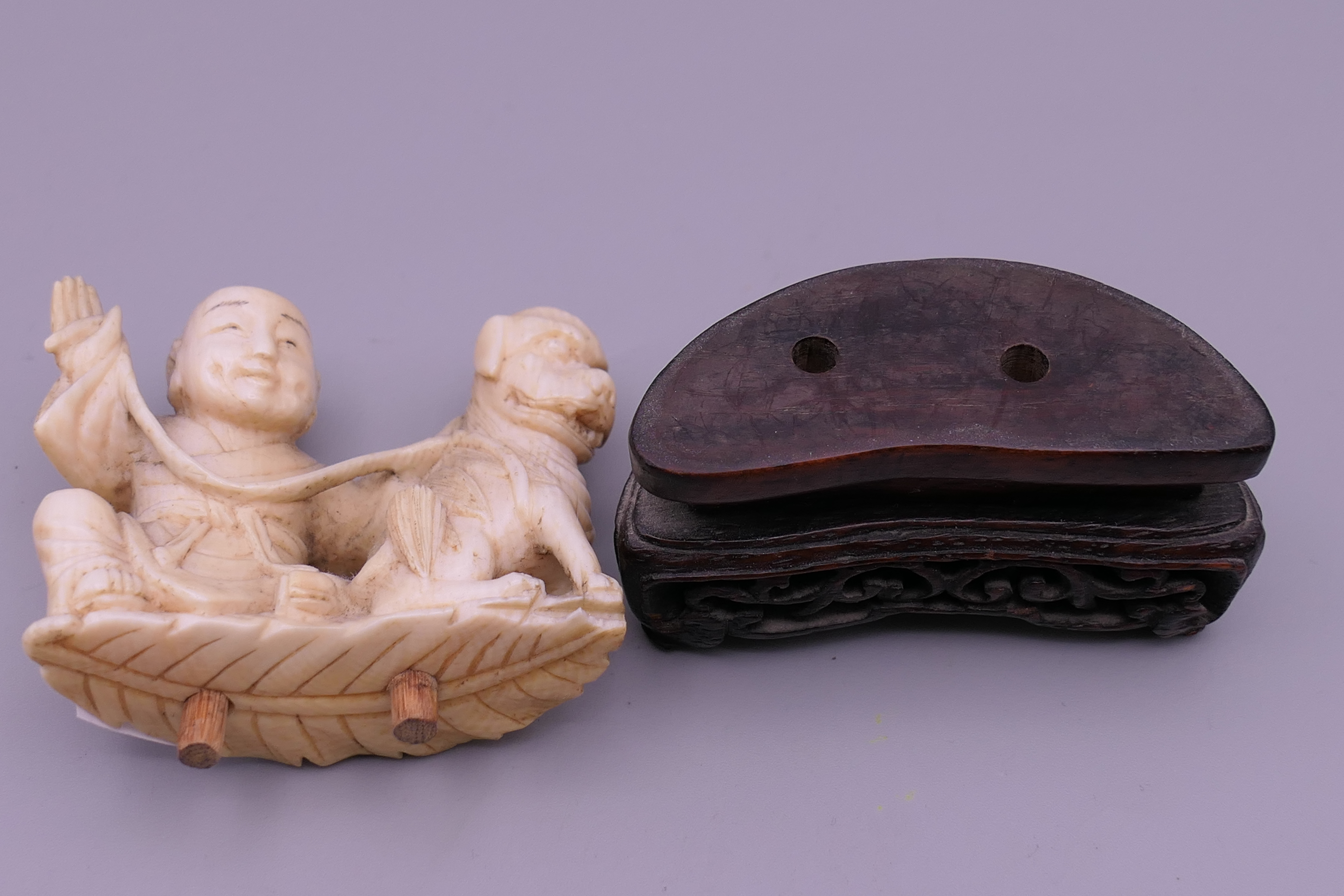 A 19th century Chinese carved ivory model of a boy and dog, mounted on a pierced wooden stand. 7. - Image 2 of 5