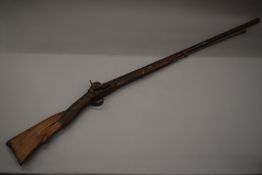 A 19th century musket with unmarked white metal inlaid inscription to the barrel and with dog form