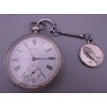 A silver Waltham pocket watch. 5 cm diameter.