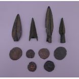 Four Iron Age arrowheads and a quantity of ancient coins.