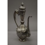 A Tibetan silver on copper repousse decorated ewer. 49 cm high.