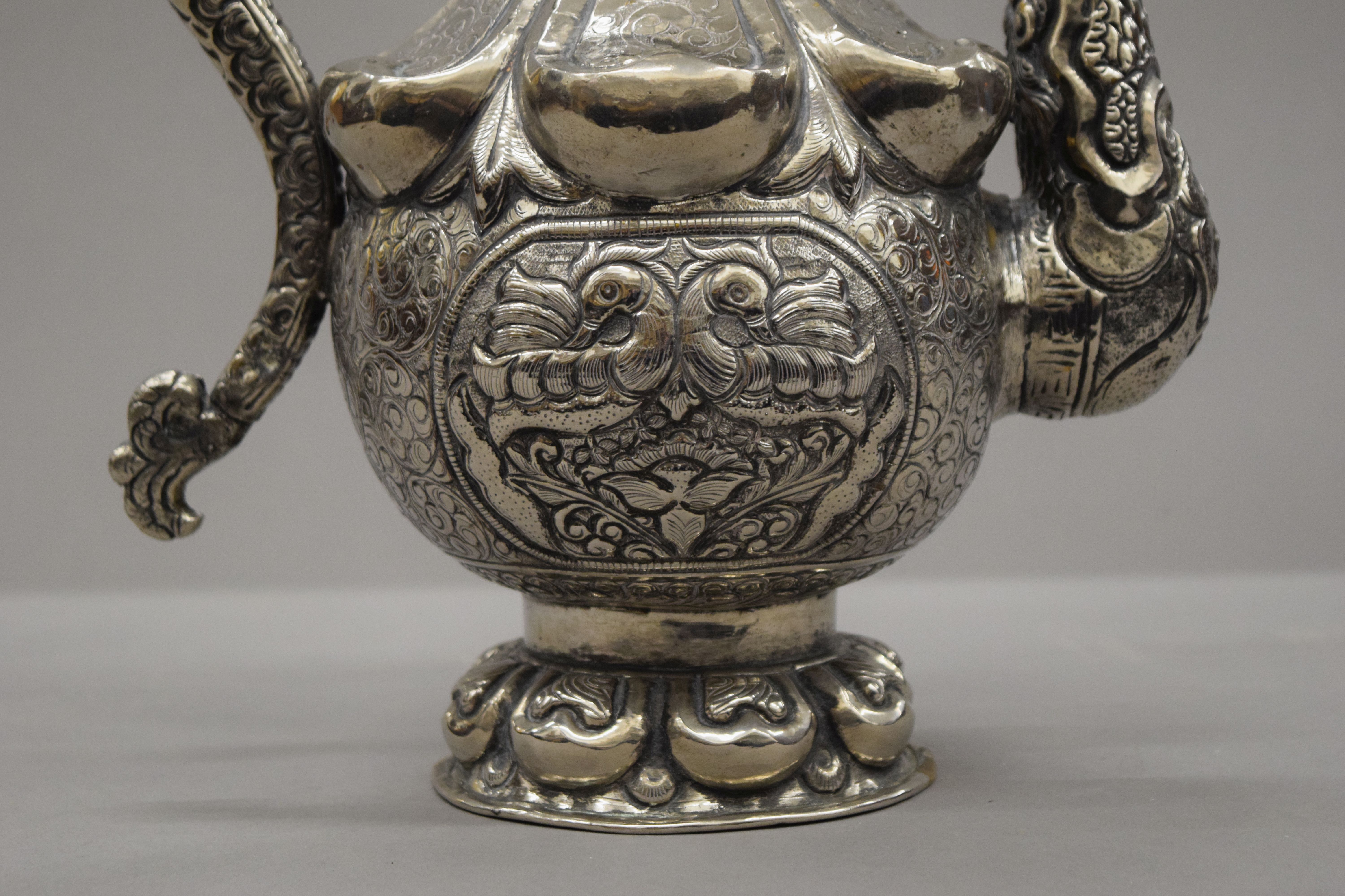 A Tibetan silver on copper repousse decorated ewer. 49 cm high. - Image 5 of 5