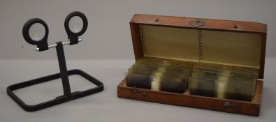 A stereoscope type B-3 in leather case and a quantity of stereoscopic glass slides in a fitted