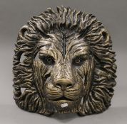A lion mask sculpture. 42.5 cm high.