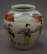 A 19th century Japanese ovoid vase decorated with three geishas in a landscape. 21 cm high.