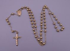 A 9 ct gold rosary bead necklace with crucifix pendant. 20.5 grammes.