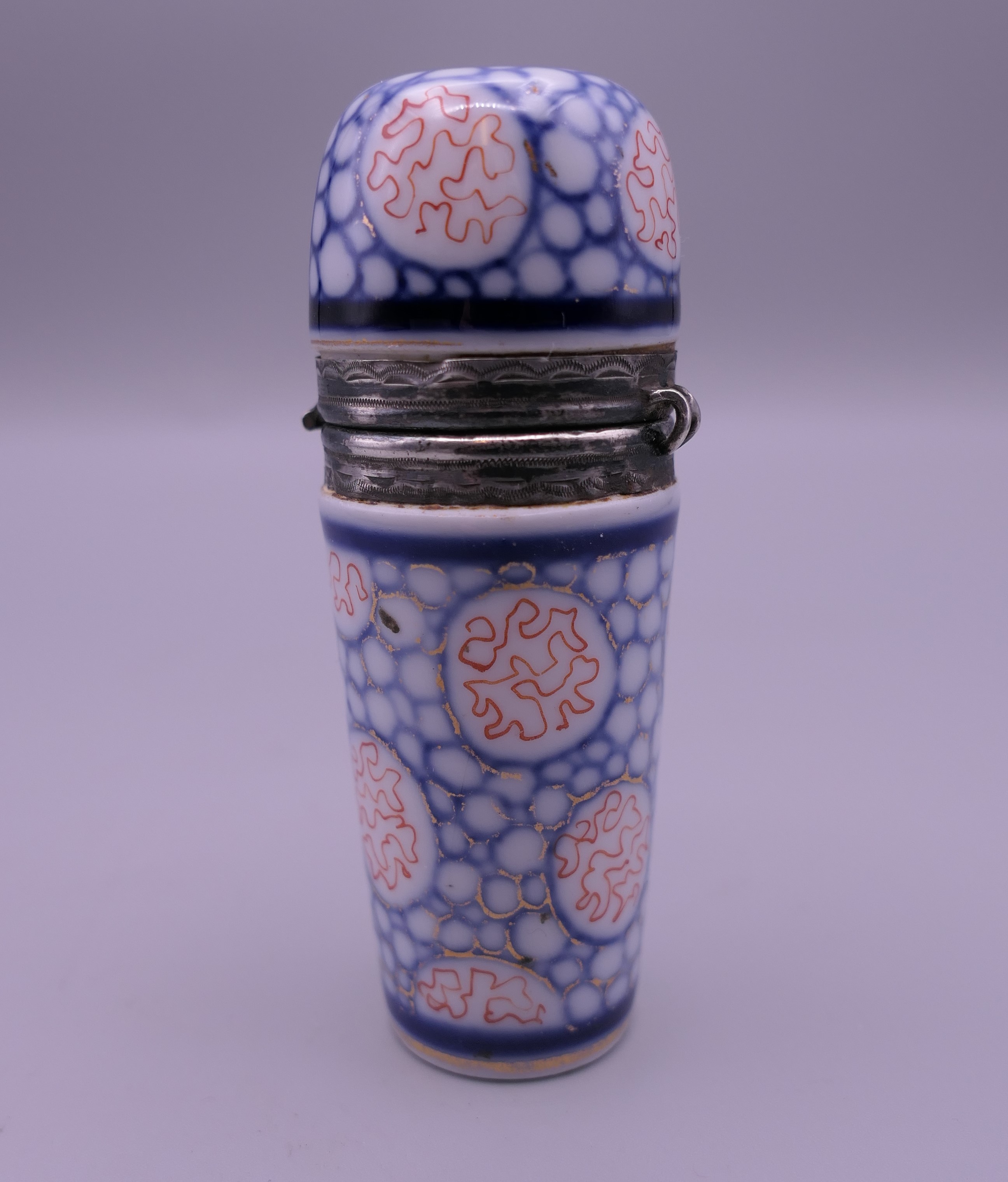 A porcelain and unmarked silver scent bottle. 7.5 cm high.