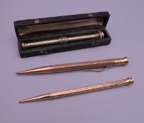 Two 9 ct gold cased propelling pencils and an unmarked example.