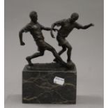 A bronze model of footballers mounted on a marble base. 21.5 cm high.