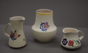 Three pieces of Poole pottery. The largest 13 cm high.