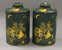 A pair of green toleware tea tins. 39 cm high.