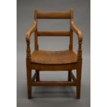 A Victorian elm child's open arm chair. 33.5 cm wide.