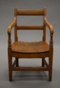 A Victorian elm child's open arm chair. 33.5 cm wide.