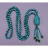 A turquoise bead necklace. 88 cm long.