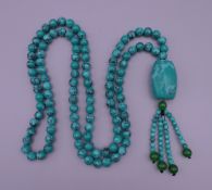 A turquoise bead necklace. 88 cm long.
