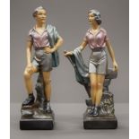 A pair of early 20th century painted plaster models of hikers. The largest 26 cm high.