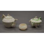 Two Belleek black mark porcelain teapots and a sugar bowl. The largest 15 cm high.