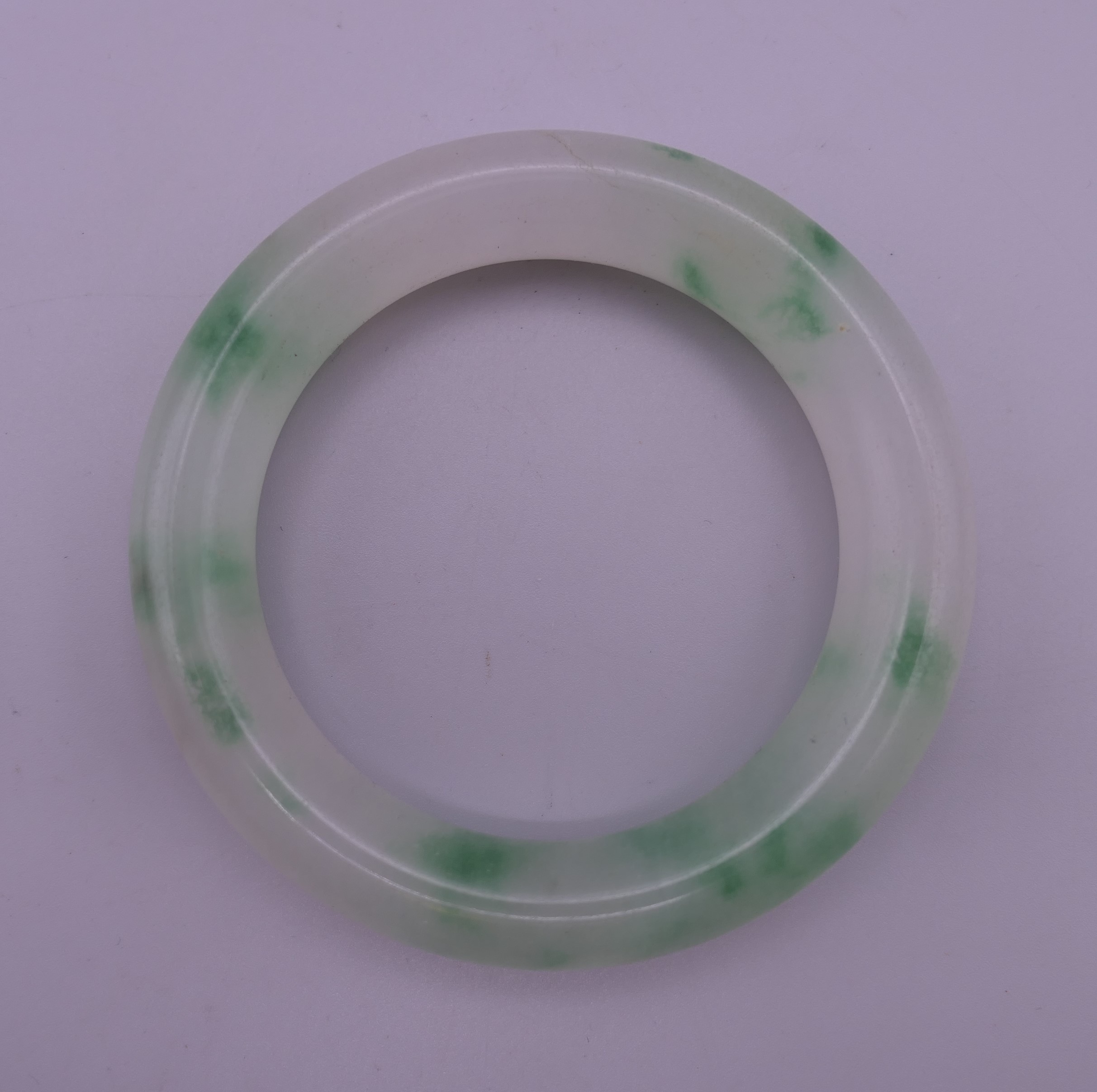 A jade bangle. 7.5 cm exterior diameter, 5.5 cm interior diameter.