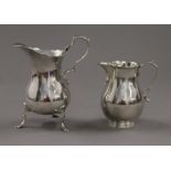 Two small silver cream jugs. The largest 11 cm high. 197.9 grammes.