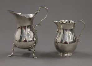 Two small silver cream jugs. The largest 11 cm high. 197.9 grammes.