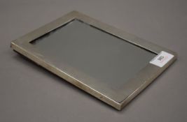 A silver framed strut mirror. 15 x 21.
