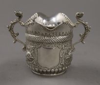 An embossed silver double lipped cream jug. 7 cm high. 89.2 grammes.