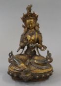 A gilt bronze model of buddha decorated with coral. 21 cm high.