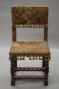 A 17th century tapestry covered oak chair. 47 cm wide, 37 cm deep, 91 cm high.