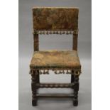 A 17th century tapestry covered oak chair. 47 cm wide, 37 cm deep, 91 cm high.