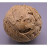 A 19th century Chinese carved ivory ball. 5 cm diameter.