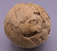 A 19th century Chinese carved ivory ball. 5 cm diameter.