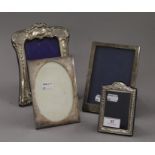 Four small silver photograph frames. The largest 20.5 cm high.