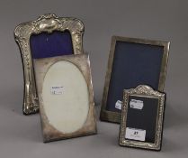 Four small silver photograph frames. The largest 20.5 cm high.