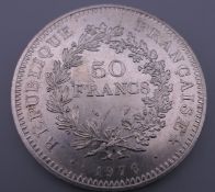 A French silver coin, cased.