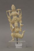 A late 19th/early 20th century Indian ivory carving of dancers mounted on a later plinth base.