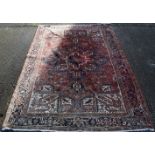 A large Persian red ground wool rug. 345 x 250 cm.