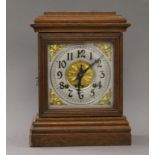 An Ansonia oak mantle clock. 24 cm wide.