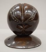 A carved wooden model of a coco de mer. 17 cm high.