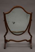 A Victorian inlaid mahogany shield shape dressing table mirror. 53.5 cm wide.