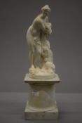 An 18th century French porcelain luneville figure, on a wooden stand. 35 cm high overall.