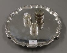 A silver plated salver, two silver napkin rings and a silver plate mounted barrel form pepper.