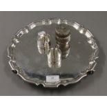 A silver plated salver, two silver napkin rings and a silver plate mounted barrel form pepper.