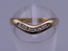 A 9 ct gold diamond wishbone ring. Ring size L. 1.8 grammes total weight.