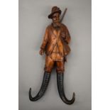 A Blackforest whip hanger carved as a huntsman. 26 cm high.