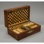 An antique oak fitted games compendium. 30.5 cm wide.