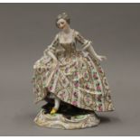 A painted porcelain figurine, the underside with blue painted Serves mark. 12.5 cm high.