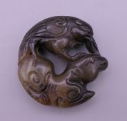 A Chinese carved jade roundel. 5 cm diameter.