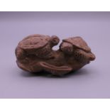 A carved wooden netsuke formed as two turtles. 6 cm long.