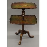 A painted papier mache and mahogany two-tier side table. 66 cm high.